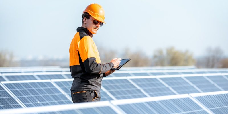 engineer-servicing-solar-panel-on-electric-plant.jpg
